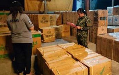<p><strong>SMUGGLED CIGARETTES.</strong> A team of police and customs personnel inspect boxes containing P7.6 million worth of assorted smuggled cigarettes that were seized off Sta. Cruz Island, Zamboanga City on Tuesday (Feb. 7, 2023). The shipment came from Jolo, Sulu. <em>(Photo courtesy of Area Police Command - Western Mindanao)</em></p>
