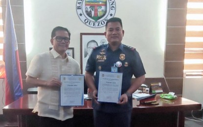 <p><strong>TWIN RECOGNITIONS.</strong> Lt. Col. Marlon Cabataña (right), Tiaong police station chief, shows the two certificates of recognition awarded by the Quezon Police Provincial Office for having the most number of suspects arrested and conducting five successful anti-illegal drug operations in this undated photo. Mayor Vincent RJ Mea (left) said he will extend his all-out support to the police for their logistics and incentives. <em>(PNA photo by Belinda Otordoz)</em></p>