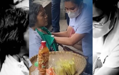 <p><strong>HEROISM.</strong> Angyl Faith Ababat is seen in this cropped video footage applying pressure to the wound at the neck of fruit vendor Bernadita Zamora on Jan. 30, 2023. Mayor Michael Rama on Tuesday (Feb. 7) said Ababat and her classmate Kristianne Joice Noelle Ona will receive the "Mayor's Award" during the Cebu City Charter Day celebration on Feb. 24, to recognize their courage in helping save a life.<em> (Photo courtesy of the University of Cebu)</em></p>