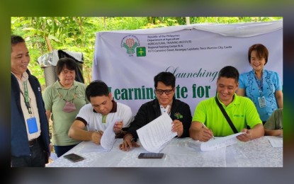 <p><strong>URBAN FARMING</strong>. Ric Jason Arreza, Learning Site focal person of ATI-Calabarzon, Dr. Rolando Maningas, ATI Region 4A Center director, and Michael Triviño of Myrtle’s Farm (seated, from left) sign a memorandum of agreement for the accreditation of the latter’s farm as a Learning Site for Agriculture. Looking on are (standing from left) Bibiano Concibido Jr., regional manager of the Philippine Coconut Authority 4A; Dr. Anna Clarissa Mariano, Quezon Provincial Agriculturist; and engineer Sheena Estanero, executive assistant of Lucena City Mayor Mark Alcala. <em>(PNA photo by Belinda Otordoz)</em></p>