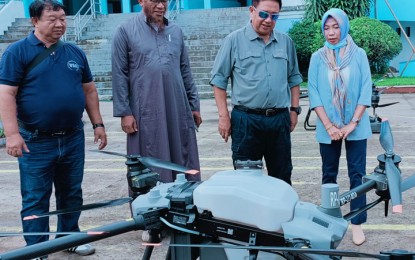 <p><strong>DRONES.</strong> The Basilan provincial government has bought two drones to be utilized for spraying pesticides at rubber plantations affected by Pestalotiopsis disease in the area. Basilan Governor Hadjiman Hataman-Salliman (2nd from right) says the drones worth P3.4 million were tested Wednesday (Feb. 8, 2023) in Isabela City.<em> (Photo courtesy of Ronda del Basilan)</em></p>