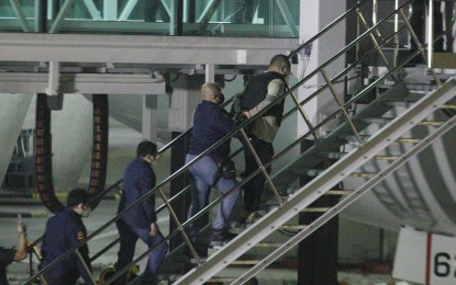 <p><strong>DEPORTED.</strong> Two more Japanese fugitives -- Tomonobu Saito and Yuki Watanabe -- board a Japan Airlines flight on Wednesday (Feb. 9, 2023) night. One of them has the alias "Luffy," the leader of a criminal ring behind the series of violent robberies in the east Asian nation. <em>(PNA photo by Ben Pulta)</em></p>
