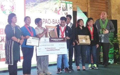 <p><strong>BEST TOURISM VILLAGE</strong>. Village leaders of the Hapao-Baang-Nungulunan clustered tourism village in Hungduan town, Ifugao province accept the top prize as the Best Cordillera Tourism Village in a competition by the Department of Tourism-Cordillera, during a ceremony at the Baguio Country Club on Wednesday (Feb, 8, 2023). DOT-Cordillera regional director Jovita Ganongan (leftmost) said the best tourism village contest is in line with the agency's efforts to promote "Filipinism." <em>(PNA photo by Liza T. Agoot)</em></p>
