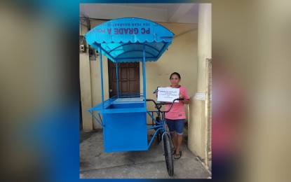 <p><strong>GOVERNMENT AID.</strong>  Manuela Centillas, a mother of 7 and a solo parent receives a Negocart in Nabua, Camarines Sur on Thursday (Feb. 9, 2023). DOLE Bicol provided PHP1.1 million worth of livelihood assistance to 63 parents and guardians of child laborers in Nabua and Bombon towns in Camarines Sur province. <em>(Photo courtesy of DOLE Bicol) </em></p>