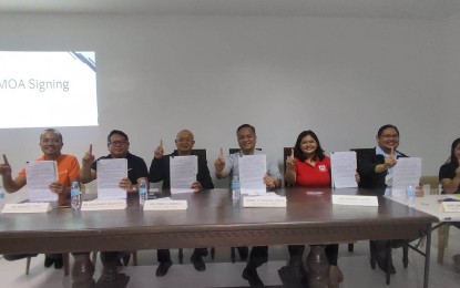 <p><strong>PRODUCT ENHANCEMENT</strong>. Officials from the Departments of Science and Technology (DOST), Social Welfare and Development (DSWD), the municipality of Bulan and World Vision sign on Wednesday (Feb. 8, 2023) a memorandum of agreement (MOA) as partners for the enhancement, promotion, product development, and improve quality of sardines-making in the province of Sorsogon. Said agencies agreed to pool their efforts and resources for the implementation of the project "Enhanced Process and Quality of Sardines Making". <em>(Photo courtesy of DOST Bicol) </em></p>