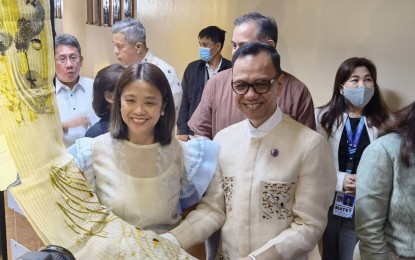 <p><strong>LOCALLY MADE.</strong> Senator Nancy Binay (left) strikes a pose with designer Anthony Legarda Cruz and his works at the "KatHABI" exhibit at the Senate in Pasay City on Monday (Feb. 13, 2023). The event showcases Philippine cotton, silk, and other local tropical fabrics. <em>(PNA photo by Wilnard Bacelonia) </em></p>