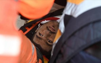 <p><strong>RESCUED </strong>A man trapped in the rubble is being aided by the rescue team as they raise against time to save more people.  (<em>Anadolu)</em></p>