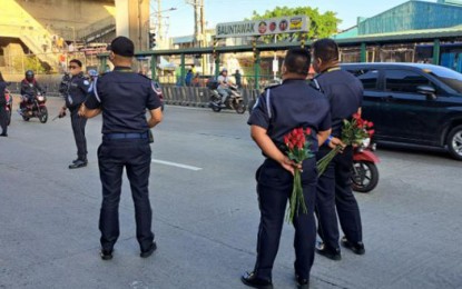 <p><strong>SPECIAL OPERATION</strong>. Land Transportation Franchising and Regulatory Board (LTFRB) enforcers holding roses surprise unsuspecting motorists during traffic stops on Tuesday (Feb. 14, 2023). LTFRB chair Teofilo Guadiz III said the special operation in celebration of Valentine’s Day aims to lighten the mood of commuters. <em>(Photo courtesy of LTFRB)</em></p>