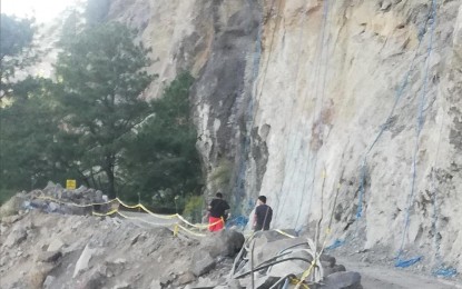 <p><strong>ROAD STABILITY</strong>. Road repair continues on Halsema Highway at the Mt. Data Cliff in Bauko, Mountain Province in this Feb. 5, 2023 photo. The provincial Disaster Risk Reduction Management Council (PDRRMC) has set two hours in the morning and two hours in the afternoon daily, except weekends, as a window period to allow motorists to traverse the area. <em>(PNA photo by Liza T. Agoot)</em></p>