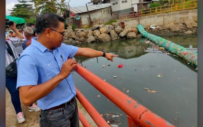 <p><strong>TRASH TRAP PROJECTS.</strong> Regional Executive Director Henry Adornado, of the Department of Environment and Natural Resources in Northern Mindanao, inspects the trash trap project in Barangay Lapasan, Cagayan de Oro City on Friday (Feb. 17, 2023). The trash trap projects totaled PHP500,000 with the management assigned to village officials. <em>(PNA photo by Ercel Maandig)</em></p>