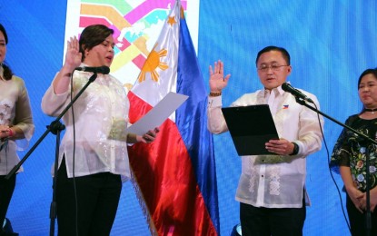 <p><strong>MINDANAO DEVELOPMENT.</strong> Senator Christopher Lawrence Go (right) takes his oath before Vice President Sara Z. Duterte on Thursday night (Feb. 16, 2023) in Davao City as ex-officio member of the Board of Directors of the Mindanao Development Authority representing the Philippine Senate. Go vowed to help with the development initiatives in Mindanao which would generate more jobs for the Mindanawons and entice more investors to come to the region. <em>(PNA photo by Robinson Niñal Jr.)</em></p>