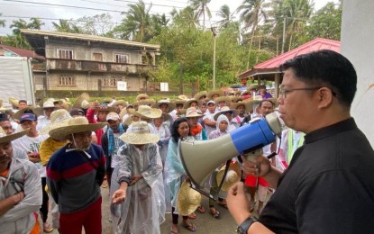<p><strong>BLESSINGS</strong>. Fr. Ramil Sabillo of the St. Joseph Husband of Mary Parish in Real, Quezon delivers a message after blessing the members of the Dumagat-Remontados tribe prior to a protest march against the construction of Kaliwa Dam on Sunday (Feb. 19, 2023). The marchers are hoping for an audience with President Ferdinand R. Marcos Jr. about their concerns on the construction of the dam in General Nakar once they reach Malacañang on Feb. 23.<em> (Courtesy of Stop Kaliwa Dam Network)</em></p>