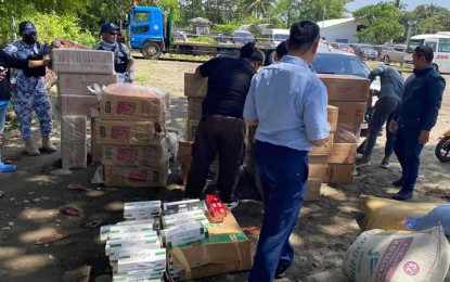 <p><strong>SMUGGLED CIGARETTES.</strong> Personnel of the Coast Guard District Southwestern Mindanao inspect the seized cigarettes worth PHP2.1 million at the Galas feeder port in Dipolog City, Zamboanga del Norte, on Monday (Feb. 20, 2023). The contraband is part of the PHP92.2 million worth of illicit goods seized by authorities in separate anti-smuggling operations in Zamboanga and Sulu since Feb. 18, 2023. <em>(Photo courtesy of CGDSWM)</em></p>