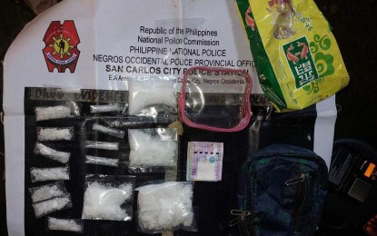 <p><strong>BUY-BUST</strong>. Operatives of San Carlos City Police Station in Negros Occidental seize PHP1.469 million worth of shabu during a buy-bust in Barangay 6 on Monday night (Feb. 20, 2022). Arrested suspect Mark John Quijano, 23, has been tagged as a high-value individual. <em>(Photo courtesy of NegOcc-San Carlos City Police Station)</em></p>
