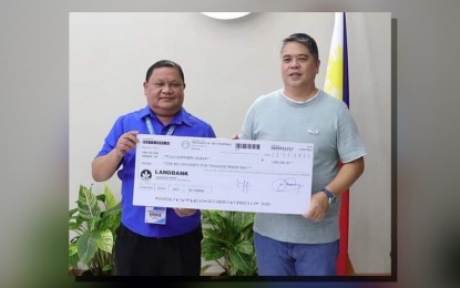 <p><strong>SOLAR DRYER.</strong> Northern Samar Governor Edwin Ongchuan (right) receives a check from Department of Science and Technology (DOST) Eastern Visayas Regional Director Ernesto Granada to fund the solar dryer project. Rice farmers in the province could dry their produce faster and reduce wastage using this local technology. <em>(Photo courtesy of DOST)</em></p>