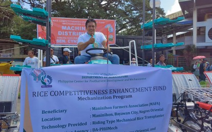 <p><strong>RICE FUND.</strong> Negros Oriental Governor Roel Degamo mounts a tractor during the turnover of farm equipment on Thursday (Feb. 23, 2023) at the Macias Sports Center in Dumaguete City. The Philippine Center for Postharvest Development and Mechanization Program turned over machinery worth PHP39.7 million as part of the Rice Competitiveness Enhancement Fund Mechanization Component. (<em>Photo courtesy of Capitol PIO)</em></p>