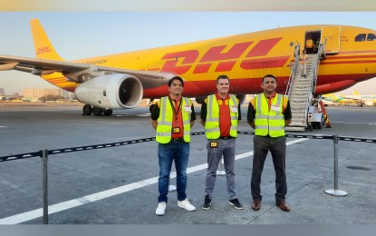 <p><strong>AIRCRAFT UPGRADE</strong>. DHL Express Philippines head of commercial Eric Queppet (left), DHL Express Philippines country manager Nigel Lockett (center), DHL Express head of operations Promod George lead the media aircraft tour of the company's upgraded aircraft A330-300 at the NAIA Complex, Pasay City on Feb. 23, 2023. The aircraft can now carry up to 55 tons from the previous capacity of 42 tons serving the Hong Kong-Manila-Cebu-Manila-Hong Kong route.<em> (PNA photo by Kris Crismundo)</em></p>