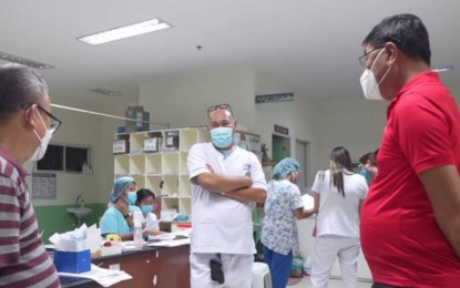 <p><strong>HOSPITAL VISIT</strong>. Mayor Renato Gustilo (right) of San Carlos City, Negros Occidental province talks to the staff of the city hospital during his visit to check on amoebiasis patients on Tuesday (Feb. 22, 2023). On Thursday (Feb. 23), the city government released a copy of Gustilo’s executive order, declaring a state of health emergency due to the surge in local amoebiasis cases. <em>(Photo courtesy of Rene Gustilo Facebook page)</em></p>