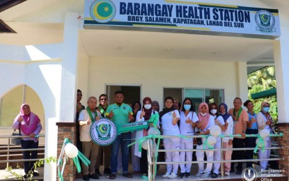 <p><strong>HEALTH FOR ALL.</strong> BARMM health minister, Dr. Rizaldy Piang (left, holding symbolic key), poses with other health officials during the inauguration of a newly-built Barangay Health Station in Barangay Salamen in Kapatagan town, Lanao del Sur province on Sunday (Feb. 26, 2023). The MOH-BARMM will construct 100 village health stations across the region this year.<em> (Photo courtesy of MOH-BARMM)</em></p>