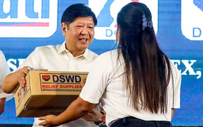 <p><strong>AID DISTRIBUTION</strong>. President Ferdinand R. Marcos Jr. leads the distribution of cash and food assistance to 3,000 beneficiaries in Mandaue City, Cebu province on Monday (Feb. 27, 2023). Marcos vowed to continue providing aid to the poor until they are able to stand on their own feet. <em>(PNA photo courtesy of Rey Baniquet)</em></p>