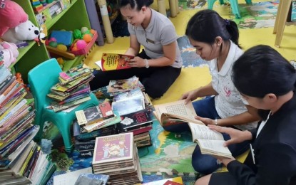 <p><strong>NEW BOOKS.</strong> Staff of the Samar Provincial Library check books donated by the Philippine Army for learners in remote communities of Samar province.  In the past three years, the provincial library has been providing additional support to villages and school libraries, giving priority to areas vulnerable to rebels' influence. <em>(Photo courtesy of Samar Provincial Library</em></p>
