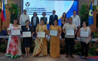 <p><strong>OUTSTANDING STAKEHOLDERS.</strong> Bangko Sentral ng Pilipinas (BSP) officials, headed by Deputy Governor Bernadette Romulo-Puyat (back row, 2nd from right) pose with the representatives from the six partner institutions recognized during the 2022 Outstanding BSP Stakeholders Appreciation Ceremonies held at the Grand Ballroom of the Sheraton Hotel in Lapu-Lapu City, Cebu on Tuesday (Feb. 28, 2023). BSP Felipe Medalla, in a video message, said the six outstanding stakeholders in the Visayas were hailed for their contributions to the central monetary authority's policies on price stability, financial stability, and safe, secure, and efficient payment and settlement systems. <em>(PNA photo by John Rey Saavedra) </em></p>
