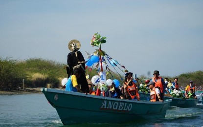 <p><strong>FLUVIAL PARADE</strong>. The image of St. William is carried in a fluvial procession along the waters off Metro Gabu and Metro La Paz on Tuesday (Feb. 28, 2023). This culminates in the city fiesta celebration in honor of its patron saint. <em>(Photo courtesy Alwyn Formantes/City Government of Laoag)</em></p>