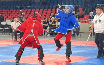 <p><strong>WINNER.</strong> Staff Sgt. Mike Bañares (right) competes in the Single Stick 18 to 45-year-old male, 81.1-90 kg during the Philippine Eskrima Kali Arnis Federation Battle of Champions held at the Ninoy Aquino Stadium inside the Rizal Memorial Sports Complex in Manila last February 24-26. Bañares won the gold medal. <em>(Philippine Army photo)</em></p>