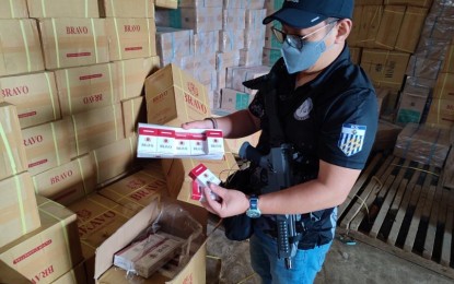 <p><strong>BUSTED. </strong>Customs Intelligence and Investigation Service at the Manila International Container Port (CIIS-MICP) chief Alvin Enciso checks smuggled cigarettes discovered in a warehouse raided by a composite team in Indanan, Sulu on Thursday (March 2, 2023). Elements from from Western Mindanao Command-Armed Forces of the Philippines (WESMINCOM-AFP), 11th Infantry Division, Philippine Army (11ID PA), Philippine Air Force-Special Operations Wing (PAF-SPOW), Joint Task Force (JTF)-Sulu, Philippine Navy-Naval Special Operations Unit (PN-NAVSOU), and PN Naval Forces also join the raid. <em>(Photo courtesy of BOC)</em></p>