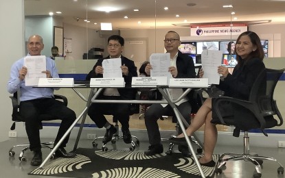 <p><strong>NEWS EXCHANGE</strong>. Philippine News Agency Deputy Executive Editor Luis Morente, PNA Executive Editor Demetrio Pisco Jr., PCO-NIB Director Raymond Burgos and PCO-NIB Assistant Director Lee Ann Pattugalan (from left) show copies of the signed cooperation agreement with Sputnik at the PNA office in Quezon City on Friday (March 3, 2023). Under the agreement, both agencies will provide each other with up-to-date information on the Philippines and Russia in the form of news articles. <em>(PNA photo by Joyce Ann Rocamora)</em></p>