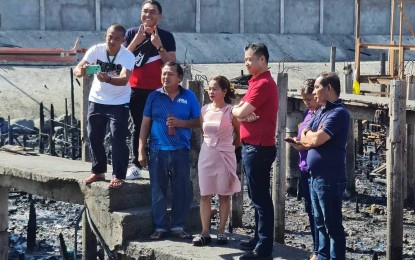 <p><strong>FIRE VICTIMS.</strong> Senator Sherwin Gatchalian (3rd right) visits the ground zero in Barangay 21-C in Davao City on Friday (March 3, 2023), where 600 of some 1,000 families are affected by the Feb. 25, 2023 conflagration. Gatchalian also extended assistance in adjoining Barangay 22-C, which was also hit by the blaze. <em>(PNA photo by Robinson Niñal Jr.)</em></p>