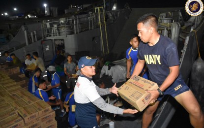 <p><strong>FAMILY FOOD PACKS.</strong> Personnel from the Philippine Navy, Air Force and Army are seen doing a "bayanihan" in loading 7,500 family food packs (FPP) on board the BRP Batak at the Naval Base Rafael Ramos in Looc, Lapu-Lapu City on Friday (March 3, 2023). Naval Forces Central public affairs chief, Lt. Michael John Savillo, said the 68 tons of FPPs are bound for Western Visayas and will be distributed among the families who are victims of calamities. <em>(Photo courtesy of Navforcen)</em></p>
