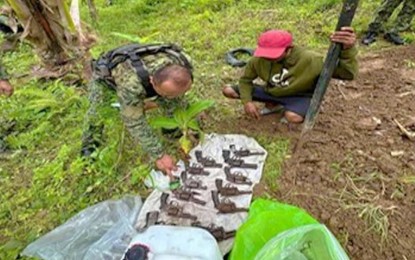<p><strong>NPA FIREARMS.</strong> A police officer accounts for the dozen hidden firearms by communist rebels and unearthed in Maitum, Sarangani province, on Thursday (March 2, 2023). A tipster bared to the police the whereabouts location of the guns. <em>(Photo courtesy of PRO-12)</em></p>