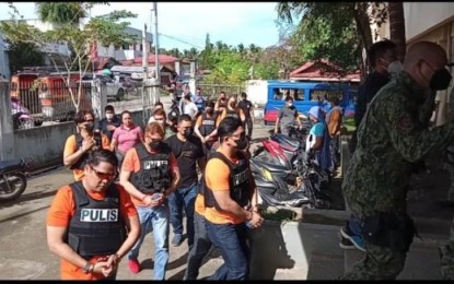 <p><strong>BAIL GRANTED.</strong> Some of the nine cops facing murder charges for the death of Calbayog City Mayor Ronaldo Aquino walk outside a court in Samar province in this undated photo. The local court granted the petition of the accused to post bail on March 7, 2023. (<em>Photo courtesy of Regie Malinao)</em></p>