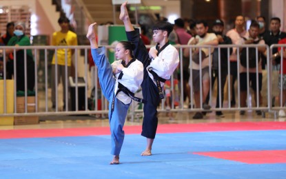 <p><strong>PODIUM FINISHERS.</strong> The Philippines’ Janina Samantha Roca (left) and Jose Lucas Llarena compete in the poomsae mixed pair event of the 16th ASEAN Taekwondo Championships at the Ayala Malls Manila Bay in Parañaque City on Friday (March 10, 2023). The duo bagged the bronze medal. <em>(PNA photo by Jess M. Escaros Jr.)</em></p>