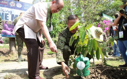 <p><strong>TREE PLANTING DRIVE.</strong> Army Chief of Staff Maj. Gen. Potenciano Camba (right) and Department of Agriculture Senior Undersecretary Domingo Panganiban water a newly planted sapling during the kick-off of the “Raising of One Million Fruit-Bearing Trees” Project at the Security and Escort Battalion’s Kamayan Area, Installation Management Command, Fort Bonifacio, Metro Manila on Thursday (March 9, 2023). Major units of the PA participated in the activity through the collective planting of fruit-bearing trees in various camps and reservations nationwide.<em> (Photo courtesy of Philippine Army)</em></p>