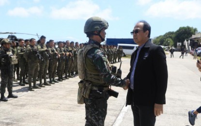 <p><strong>JOINT TASK FORCE.</strong> Defense Secretary Carlito Galvez Jr. talks to one of the military personnel assigned to the joint special task force in Negros Oriental on Saturday (March 11, 2023). Galvez urged the public to provide the task force with information that might help in the resolution of the killing of Negros Oriental Governor Roel Degamo and eight others on March 4. <em>(Courtesy of AFP)</em></p>