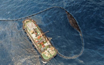 <p>A tugboat using an oil spill boom at the site of the Oriental Mindoro oil spill. <em>(Photo courtesy of Malayan Towage & Salvage Corp.)</em></p>