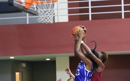 <p><strong>FAIR PLAY. </strong>The players of the University of the Philippines and Ateneo de Manila University (blue) women's basketball teams contest the rebound during a friendly match at the UP court in Diliman, Quezon City on Tuesday (March 14, 2023). The event is part of the Philippine stop of "Terre de Jeux" (Land of the Games) 2024 in preparation for the Paris Olympics next year. <em>(PNA photo by Robert Oswald P. Alfiler)</em></p>