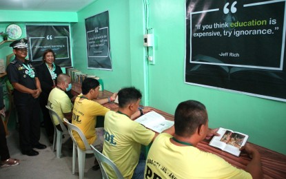 <p><strong>JAIL LIBRARY.</strong> Persons deprived of liberty read the books available at the library inside the Davao City Jail (DCJ) Annex on Monday (March 13, 2023). The first in the Davao Region, the Social Entrepreneurship Technology and Business Institute College, the backbone of “College Education Behind Bars,” funded the library's construction. <em>(PNA photo by Robinson Niñal Jr.)</em></p>