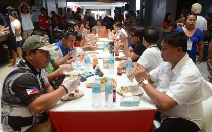 <p><strong>SAFE TO EAT</strong>. Mayor Mario Patrick Barcenas (right) joins other officials and locals in a "food trip" on Thursday (March 16, 2023) aimed to show to the public that "lechon"(roast pig) and "chicharon" (pork rind) in Carcar City are safe for human consumption despite the detection of African swine fever (ASF) virus in its three barangays. Barcenas also cited the cooperation of the hog raisers in their intervention efforts to contain the highly infectious and severe hemorrhagic disease of pigs. <em>(Photo courtesy of Atty. Eddie Barrita)</em></p>