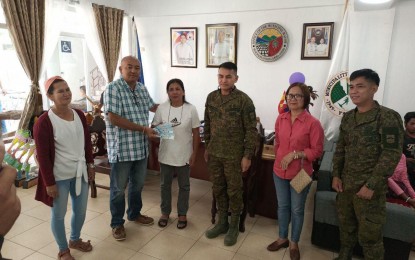 <p><strong>LIVELIHOOD ASSISTANCE</strong>. Mayor Ariel Bitong (second from left) gives livelihood assistance to members of two people's organizations in Maria Aurora town, Aurora province on March 14, 2023. The recipients are the Dianawan Upland Farmers Association and Buloy Upland Farmers Association, which received PHP30,000 and PHP35,000 worth of cash aid, respectively. <em>(Photo courtesy of the Army's 91IB)</em></p>