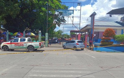 <p><strong>CRIME SCENE.</strong> Police cordon off the vehicle of Rhyolite Agregado Balili, the executive secretary of Polomolok, South Cotabato Mayor Bernie Palencia, after an attack near the town hall premises by gunmen aboard a motorbike shortly before noon Friday (March 17, 2023). Balili, a former town councilor, was critically wounded in the incident. <em>(Photo courtesy of RMN GenSan)</em></p>
