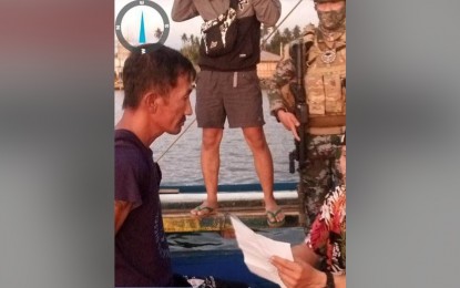 <p><strong>NO WAY OUT.</strong> Murder suspect Singbi Hassan, 45 (left), is arrested in Indanan, Sulu on Friday (March 17, 2023). One of the country’s wanted persons, he carried a PHP250,000 reward for his arrest. <em>(Courtesy of Zamboanga City Police Office)</em></p>
