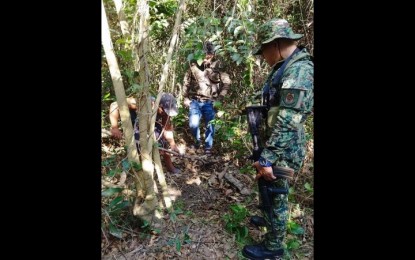 <p><strong>ARMS CACHE</strong>. Government forces discover an arms cache of communist rebels in Cuyapo town, Nueva Ecija province on Sunday (March 19, 2023) following a tip-off from a former rebel who surrendered last year. The war materiel seized included a vintage bomb, assault rifles and ammunition. <em>(Photo courtesy of Nueva Ecija Police Provincial Office)</em></p>