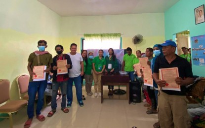 <p><strong>OWN LAND.</strong> Several of the 296 Agrarian Reform Beneficiaries (ARBs) in Pigcawayan, North Cotabato, show their certificates of land ownership award after the distribution activity on March 17, 2023.  A total of 696.3 hectares of land in Barangay Payong-Payong were distributed to the beneficiaries. <em>(Photo courtesy of DAR-North Cotabato)</em></p>