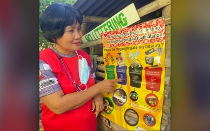 <p><strong>WASTE SEGREGATION</strong>. A village chief from Currimao, Ilocos Norte reminds her constituents to segregate their wastes properly in this undated photo. The Department of Environment and Natural Resources - Environment and Management Bureau is assisting local government units in managing the disposal of their infectious wastes. <em>(PNA photo by Leilanie Adriano)</em></p>