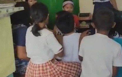 <p><strong>FRIGHTENED LEARNERS</strong>. Students and teachers of Lucso-an Elementary School in Placer town, Masbate province, kneel down to hide after hearing bursts of gunfire between government troops and New People's Army (NPA) rebels on Wednesday (March 22, 2023). Classes have been suspended in elementary and secondary schools in four towns in Masbate province due to a series of armed encounters. <em>(Screengrab from a video courtesy of Marlen Alerta Betonio)</em></p>