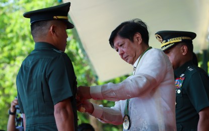 <p><strong>MODERNIZATION</strong>. President Ferdinand R. Marcos Jr. pins the gold cross award to 1st Lt. Felix Veronilla during the 126th Philippine Army (PA) founding anniversary celebration at Fort Bonifacio in Taguig City on Wednesday (March 22, 2023). Marcos reiterated his commitment to continue the military's modernization to enhance the armed forces’ capabilities to deal with national security threats. <em>(PNA Photo by REY BANIQUET)</em></p>