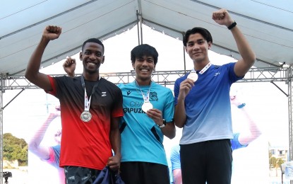 <p><strong>STUNNING WIN.</strong> Filipino-Spanish John Cabang (center) defeated reigning SEA Games champion Clinton Kingsley Bautista (right) in the men's Open 110m Hurdles final during the ICTSI Philippine Athletics Championships at the Ilagan City Sports Complex on March 22, 2023. Malaysian Shareem Aleimran Abdul Raheem (left) placed third. <em>(Photo courtesy of PATAFA)</em></p>